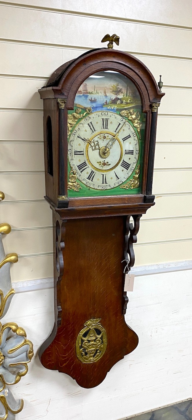 A Dutch oak wall clock with arched painted dial, height 130cm